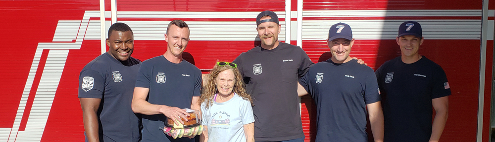 This is a photo of a chapter member poising with five firefighters.