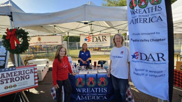 This photo shows members of Paradise Valley Chapter, NSDAR, volunteering at a Wreaths Across America event.